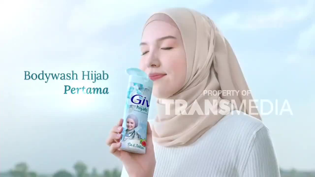 A young woman in a hijab inhales the scent of a bodywash bottle. The text "Bodywash Hijab Pertama" appears beside her. A young woman in a hijab inhales the scent of a bodywash bottle. The text "Bodywash Hijab Pertama" appears beside her.