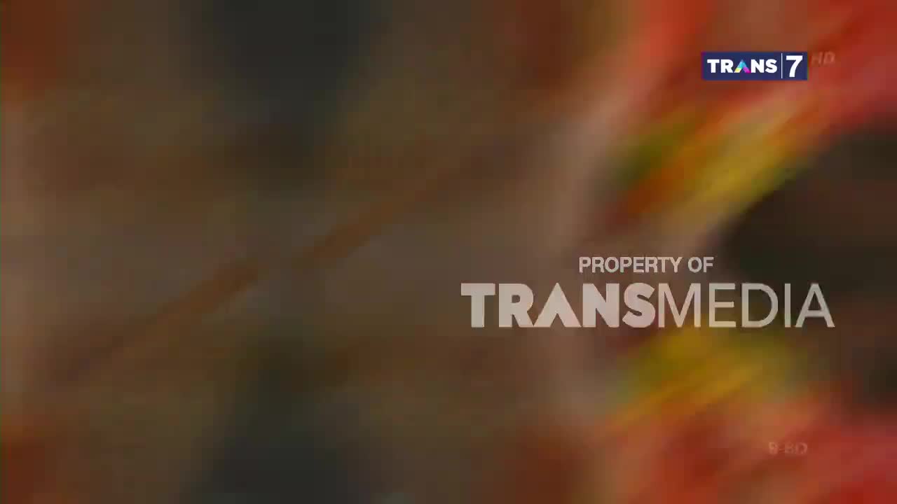 The Trans7 logo appears in the upper right corner, with "PROPERTY OF TRANSMEDIA" emblazoned across the center. Swirls of color, like a vibrant abstract painting, fill the background.