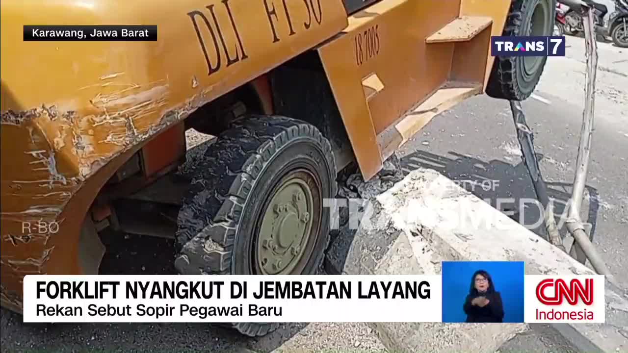The yellow forklift is tilted precariously, its front tire wedged against a concrete barrier. Scratches and dents mar the vehicle's side, evidence of a mishap on this overpass in Karawang, West Java.