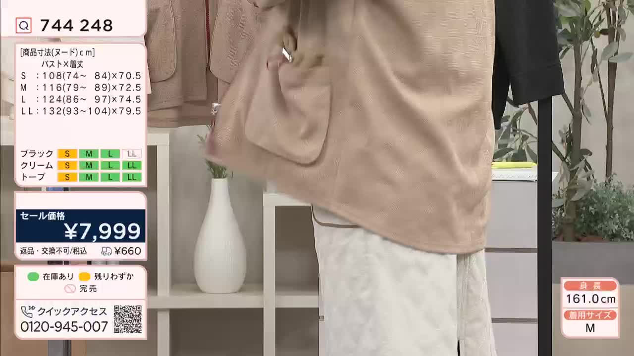 A model is demonstrating a light beige jacket on a QVC broadcast. The jacket has large pockets and a simple closure. A model is demonstrating a light beige jacket on a QVC broadcast. The jacket has large pockets and a simple closure.