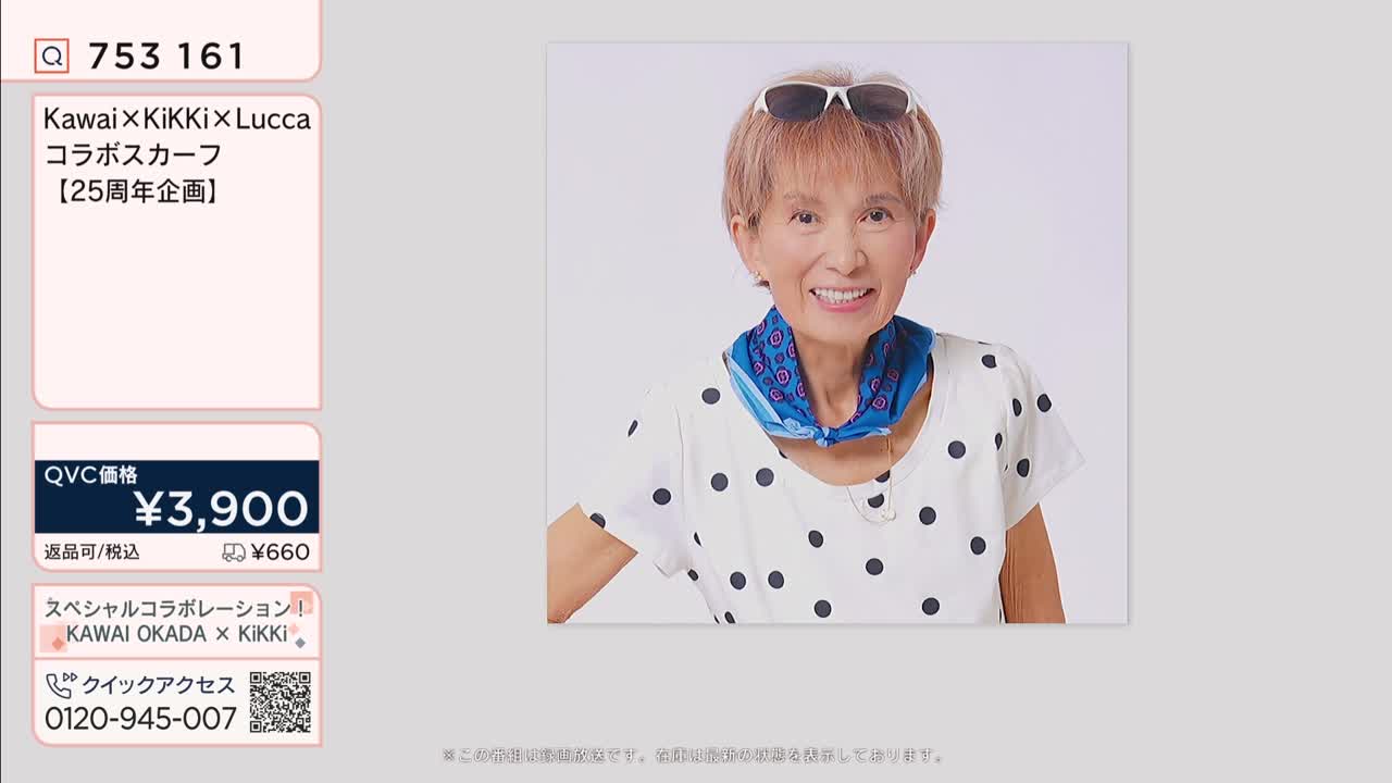 A woman smiles, her short, styled hair peeking out from under sunglasses perched on her head. She wears a white shirt dotted with black circles and a vibrant blue scarf around her neck, a detail that catches the eye.