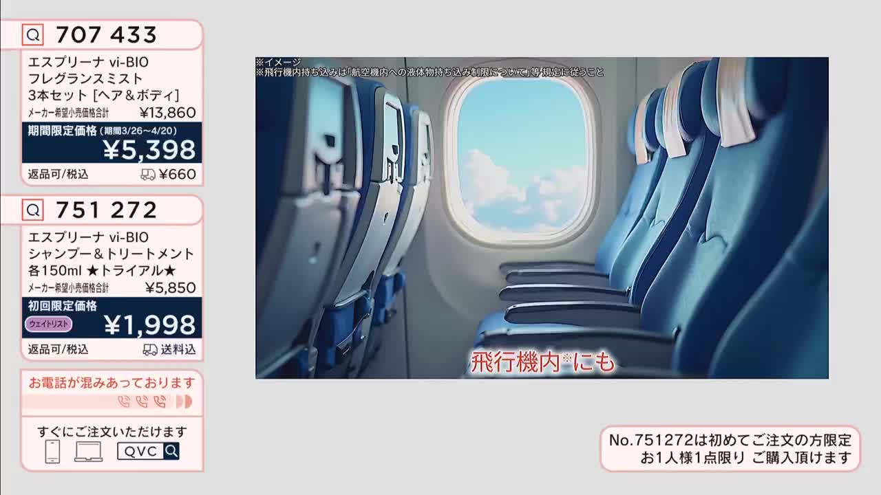 Rows of empty blue airplane seats stretch toward a bright window. The sky outside is a clear blue with fluffy white clouds.
