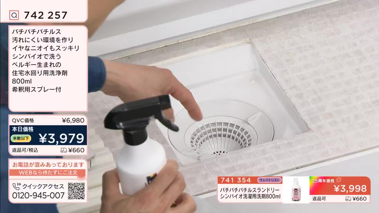 A hand holds a spray bottle over a white sink drain. The screen displays pricing information and product details for a cleaning solution.