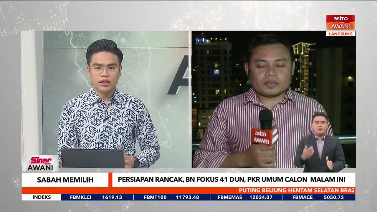 Two men on Astro Awani are reporting, one in a patterned shirt and the other holding a microphone, with a third in a smaller inset. The broadcast is covering news from Sabah, Malaysia, with financial data scrolling at the bottom.
