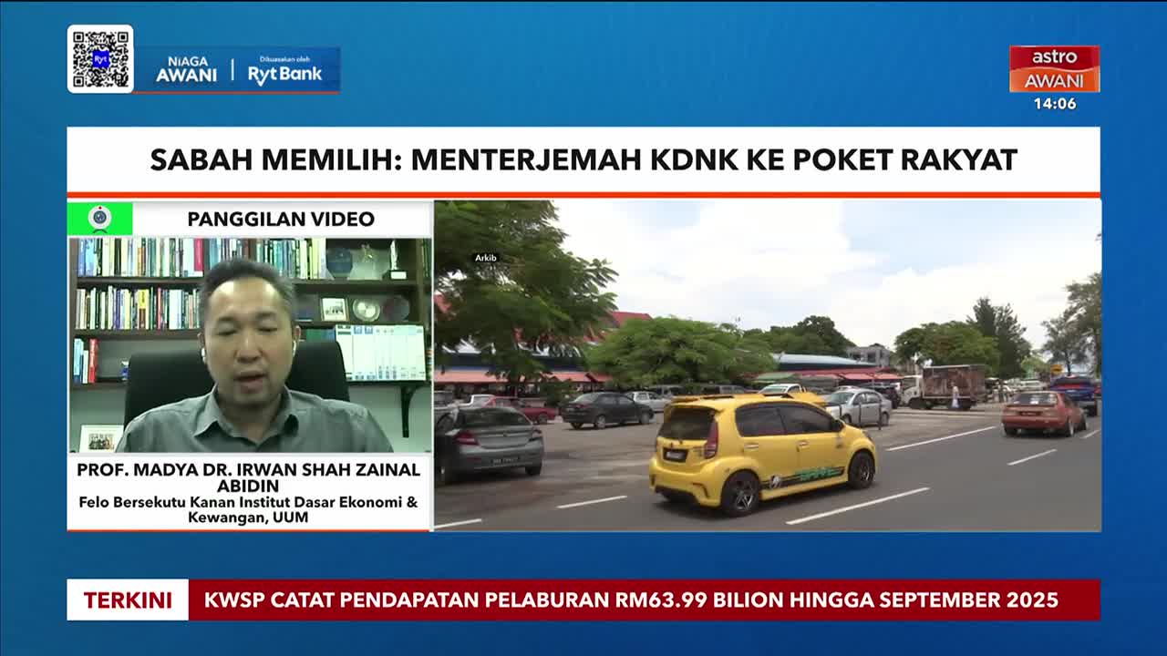 A man on Astro Awani speaks from a video call, while a yellow car drives on a road in Sabah. The news segment discusses translating the Gross Domestic Product (GDP) to the people's pockets.
