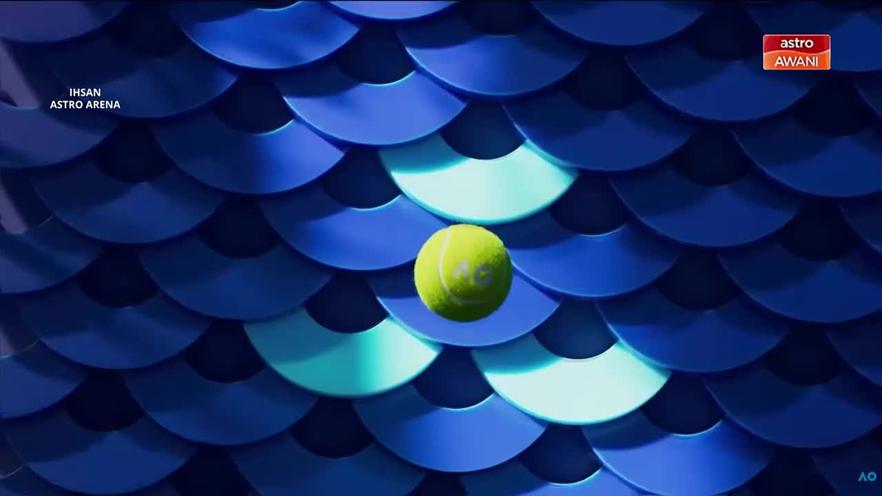 A bright yellow tennis ball hangs suspended against a backdrop of overlapping blue scales. The Astro Awani logo is visible in the upper right corner. A bright yellow tennis ball hangs suspended against a backdrop of overlapping blue scales. The Astro Awani logo is visible in the upper right corner.