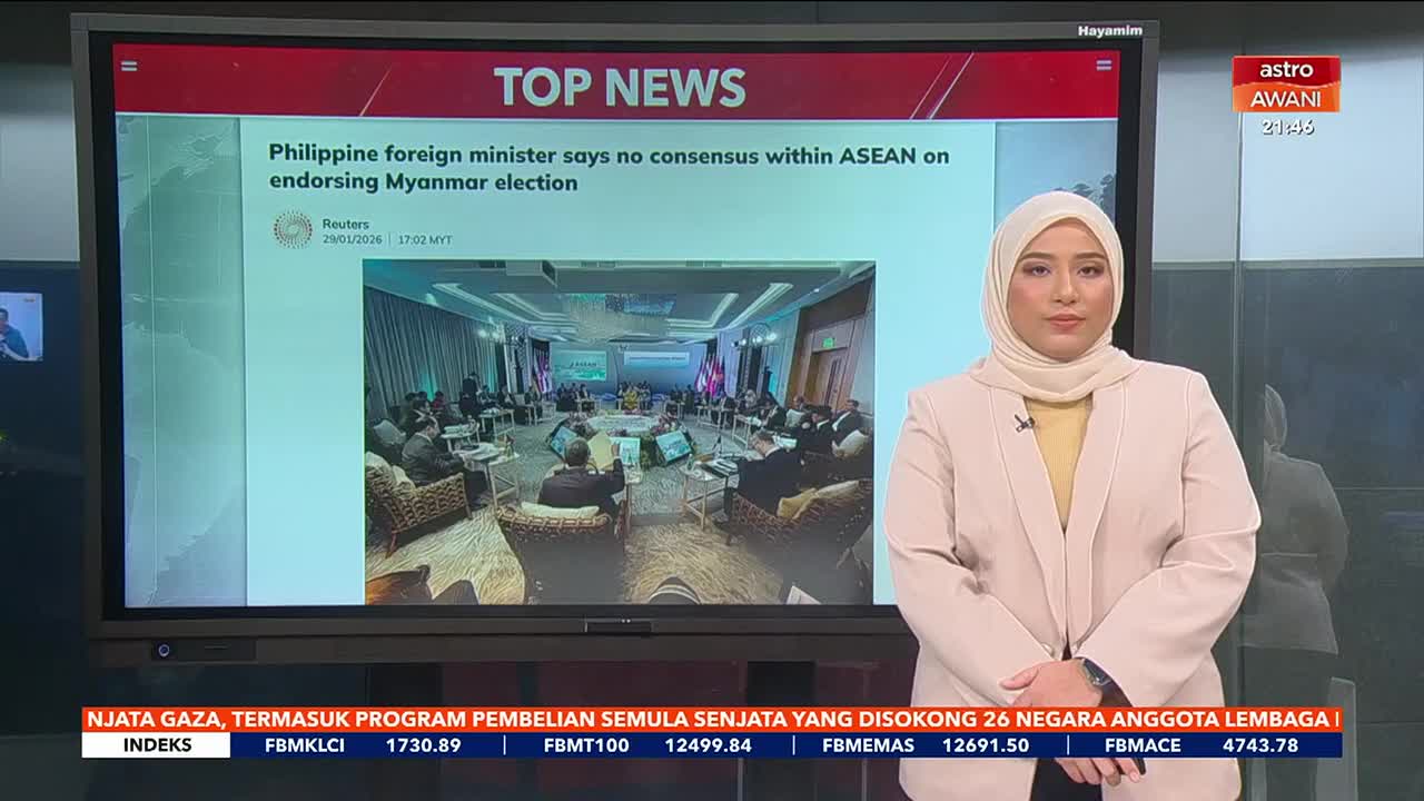 A news anchor stands in front of a large screen displaying "TOP NEWS" and a headline about the Philippine foreign minister's statement on ASEAN's stance regarding the Myanmar election. The screen also shows a photograph of a formal meeting. A news anchor stands in front of a large screen displaying "TOP NEWS" and a headline about the Philippine foreign minister's statement on ASEAN's stance regarding the Myanmar election. The screen also shows a photograph of a formal meeting.