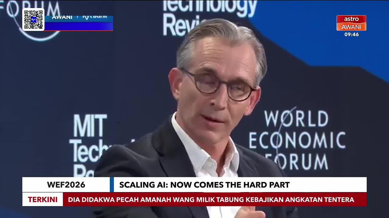 A man with glasses speaks on a stage at the World Economic Forum, his words broadcast by Astro Awani. Below him, a ticker displays "SCALING AI: NOW COMES THE HARD PART" alongside Malaysian news. A man with glasses speaks on a stage at the World Economic Forum, his words broadcast by Astro Awani. Below him, a ticker displays "SCALING AI: NOW COMES THE HARD PART" alongside Malaysian news.