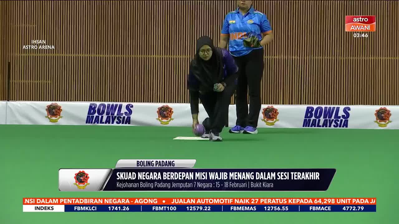 A bowler crouches, releasing a purple ball down the green carpet. Another player stands ready behind her, watching the shot unfold. A bowler crouches, releasing a purple ball down the green carpet. Another player stands ready behind her, watching the shot unfold.
