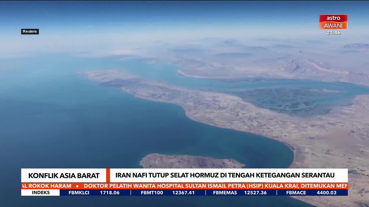 The vast blue water stretches out, meeting a rugged, dry coastline. A narrow channel cuts through the land, leading to a wider bay dotted with islands.