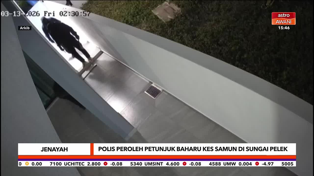 A person walks along a covered walkway, their silhouette stark against the bright floor. The Astro Awani news ticker at the bottom indicates the report is from Malaysia.