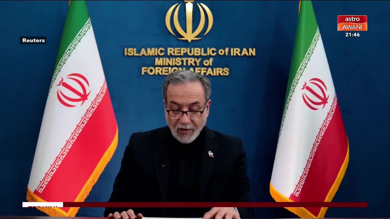 A man with glasses and a beard speaks at a podium, flanked by Iranian flags. The "Islamic Republic of Iran Ministry of Foreign Affairs" is written behind him, with the Astro Awani logo visible in the corner.