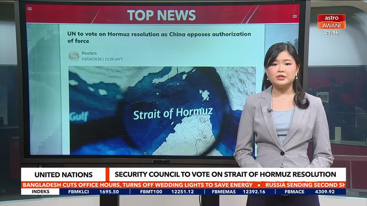 A news anchor stands beside a large screen displaying "TOP NEWS" and a map of the Strait of Hormuz. Below, a ticker scrolls with headlines, including one about a UN vote and another about Bangladesh's energy-saving measures.
