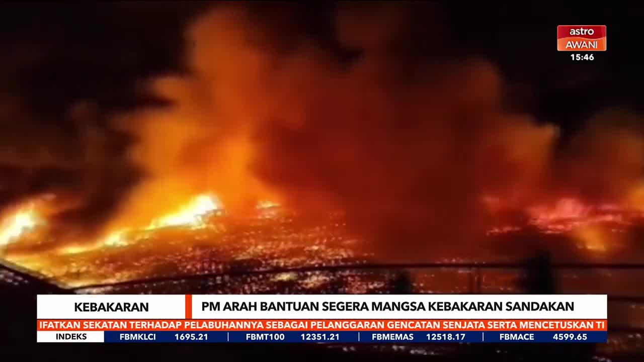 Flames erupt from buildings, painting the night sky with intense orange and red hues. Thick smoke billows upwards, obscuring the details of the inferno.