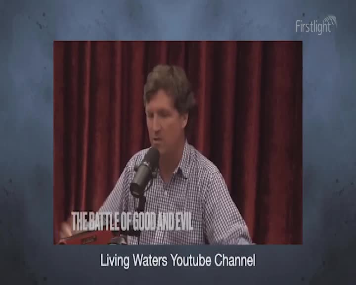 A man in a checkered shirt speaks into a microphone, his words likely broadcast by Firstlight. The backdrop is a dark red curtain, and the text "THE BATTLE OF GOOD AND EVIL" is superimposed on the screen.
