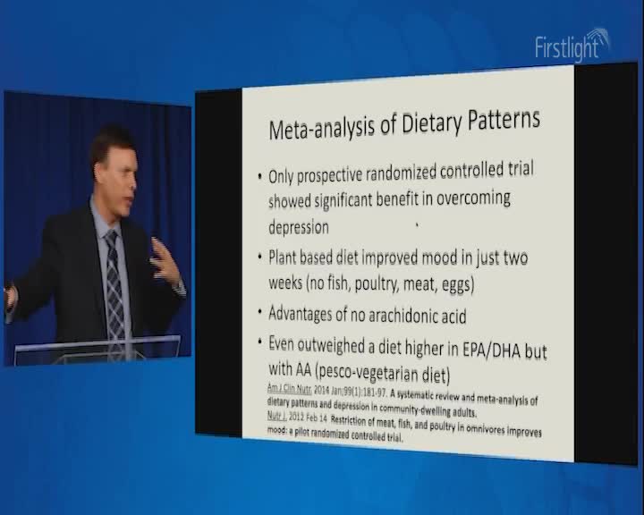 A man in a suit gestures emphatically as he speaks, his words appearing on a projected slide. The slide details a meta-analysis of dietary patterns, highlighting benefits for mental well-being.