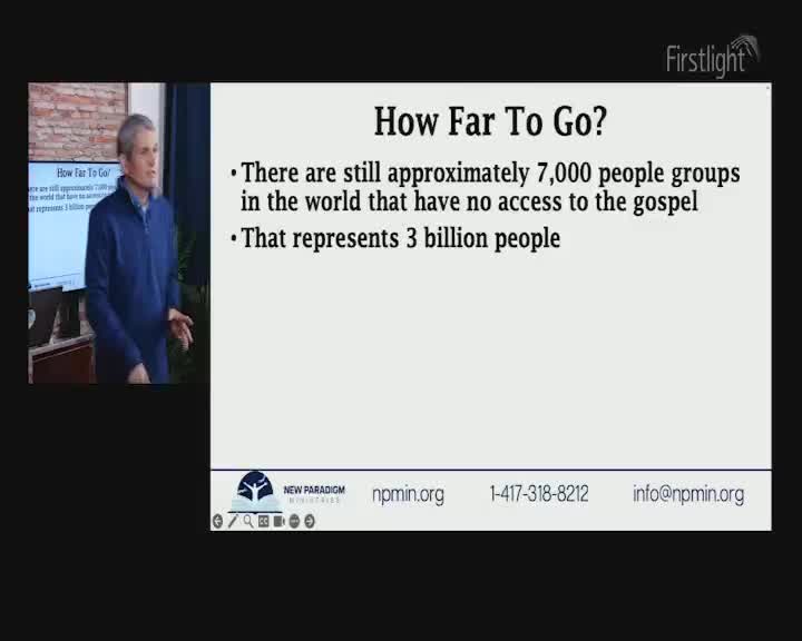 A man in a blue zip-up jacket stands to the left of a screen displaying text. The screen's title, "How Far To Go?", is followed by bullet points about unreached people groups. The Firstlight logo appears in the top right corner. A man in a blue zip-up jacket stands to the left of a screen displaying text. The screen's title, "How Far To Go?", is followed by bullet points about unreached people groups. The Firstlight logo appears in the top right corner.