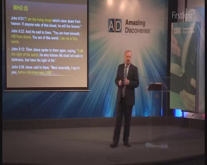 A man in a suit stands on a stage, gesturing as he speaks. Behind him, a projector displays biblical verses. The "Amazing Discoveries" logo and "Firstlight" are visible on the screen. A man in a suit stands on a stage, gesturing as he speaks. Behind him, a projector displays biblical verses. The "Amazing Discoveries" logo and "Firstlight" are visible on the screen.