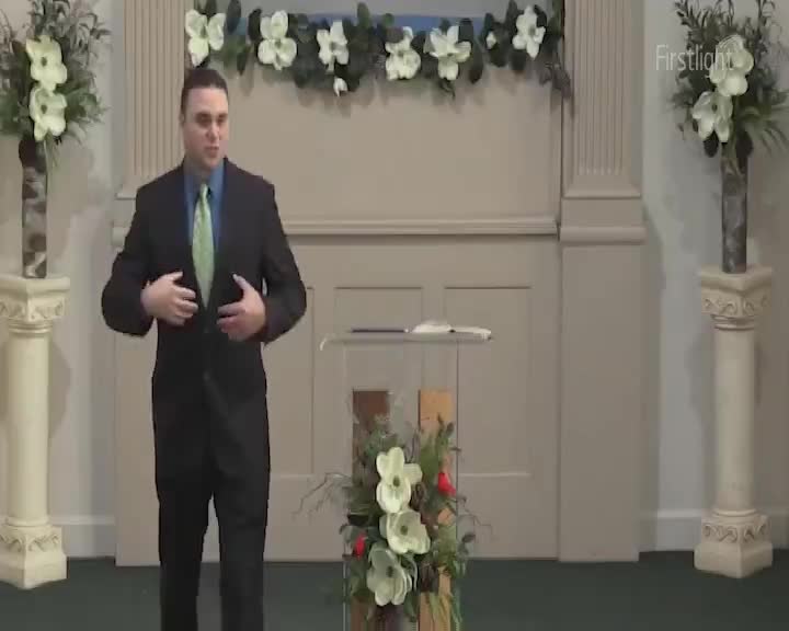 A man in a suit gestures with his hands, his voice resonating through the quiet space. The morning sun, just beginning to paint the sky outside, casts a soft glow on the scene.