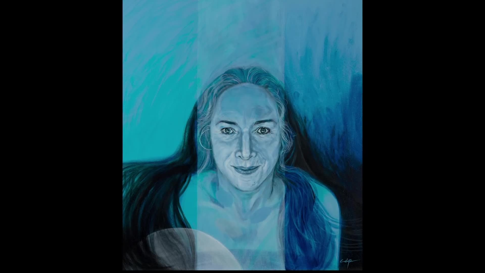 A portrait of a woman in shades of blue fills the frame, her long dark hair flowing around her shoulders. Her eyes meet mine, and she has a small, knowing smile.
