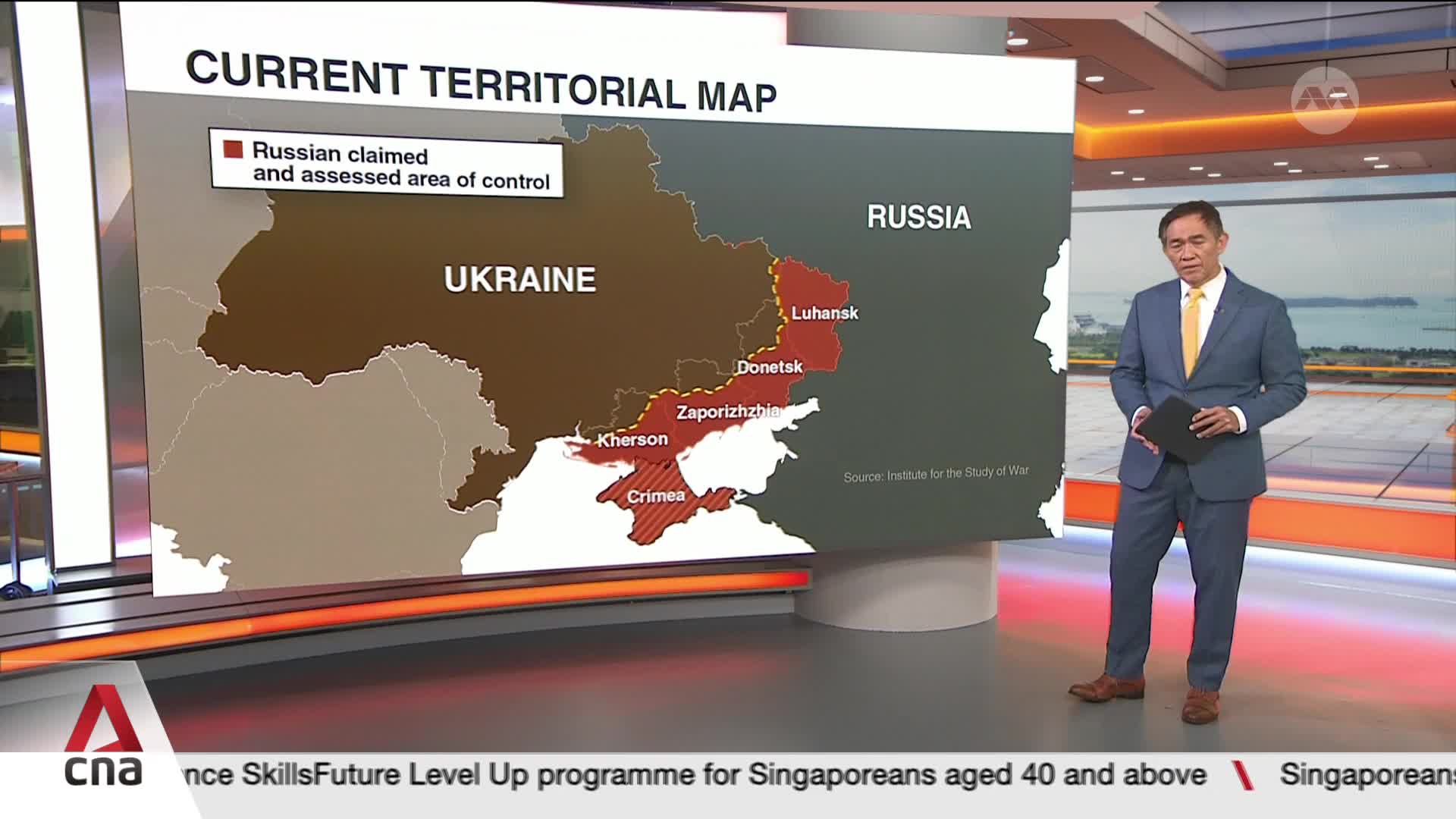 A man in a suit stands beside a map of Ukraine, pointing to the areas marked in red. The CNA International logo is visible in the corner, and a scrolling text at the bottom advertises a SkillsFuture program for Singaporeans.
