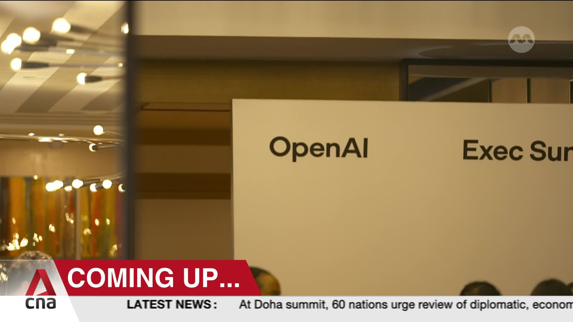 The CNA International logo is visible at the bottom, with "COMING UP..." displayed in a red banner. A sign reading "OpenAI" is prominent, likely indicating the subject of the upcoming segment.
