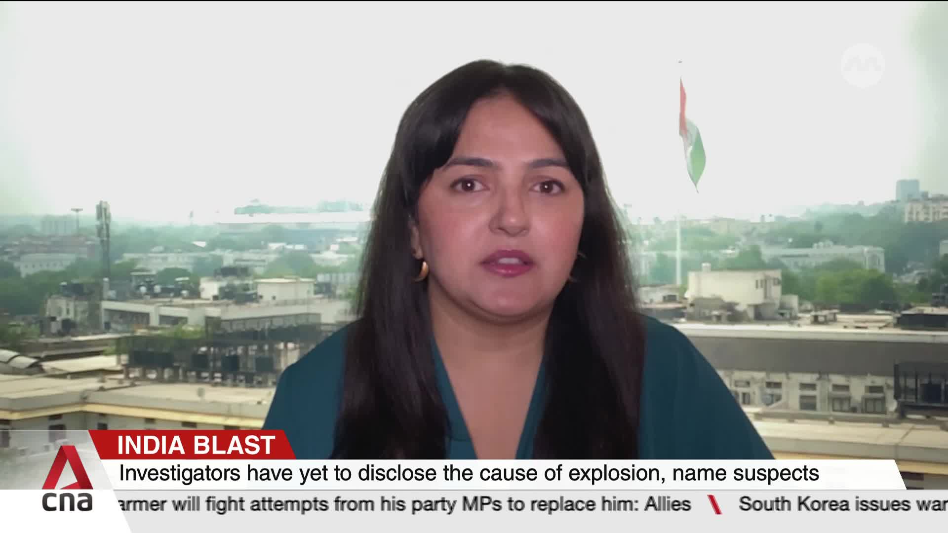 A woman with dark hair speaks directly to the camera, framed against a city skyline. Below her, the CNA International graphic identifies the segment as "India Blast."
