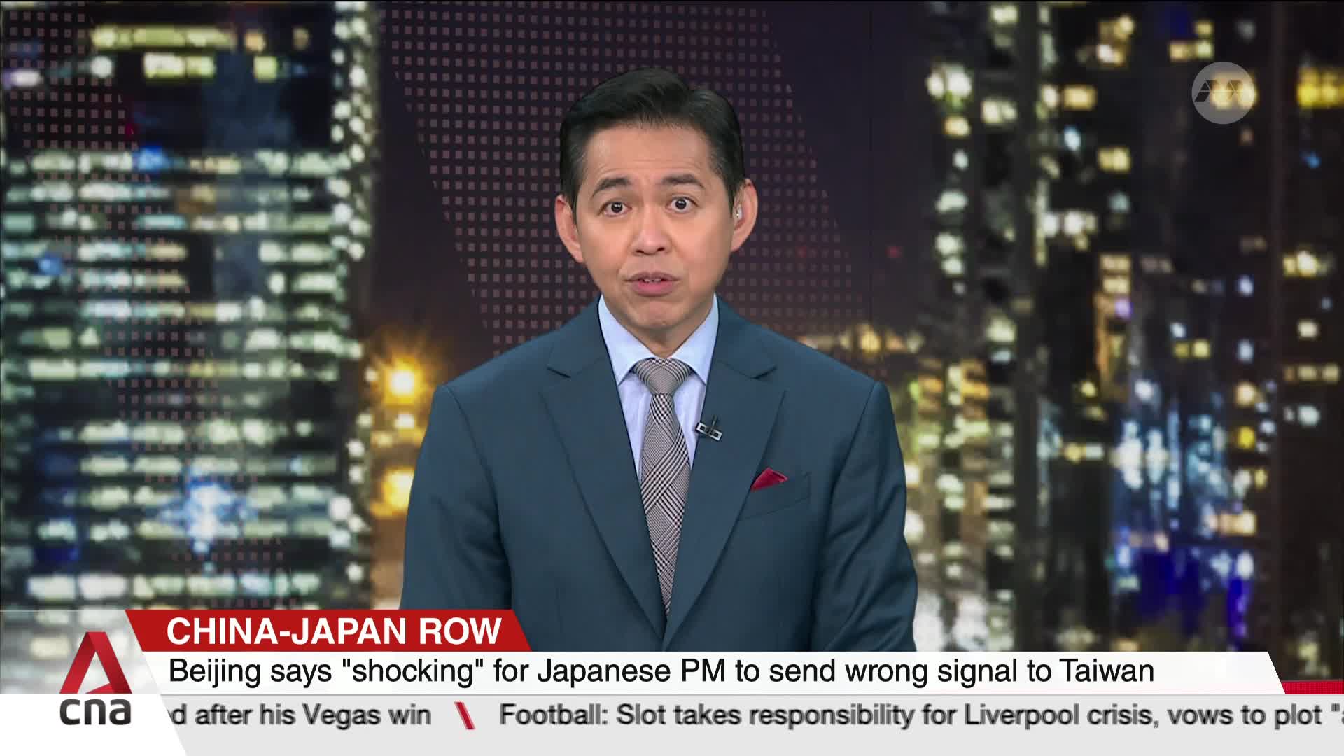 A man in a suit is speaking directly to the camera, against a backdrop of city lights. The CNA International logo and a news headline about China-Japan relations are displayed at the bottom of the screen.
