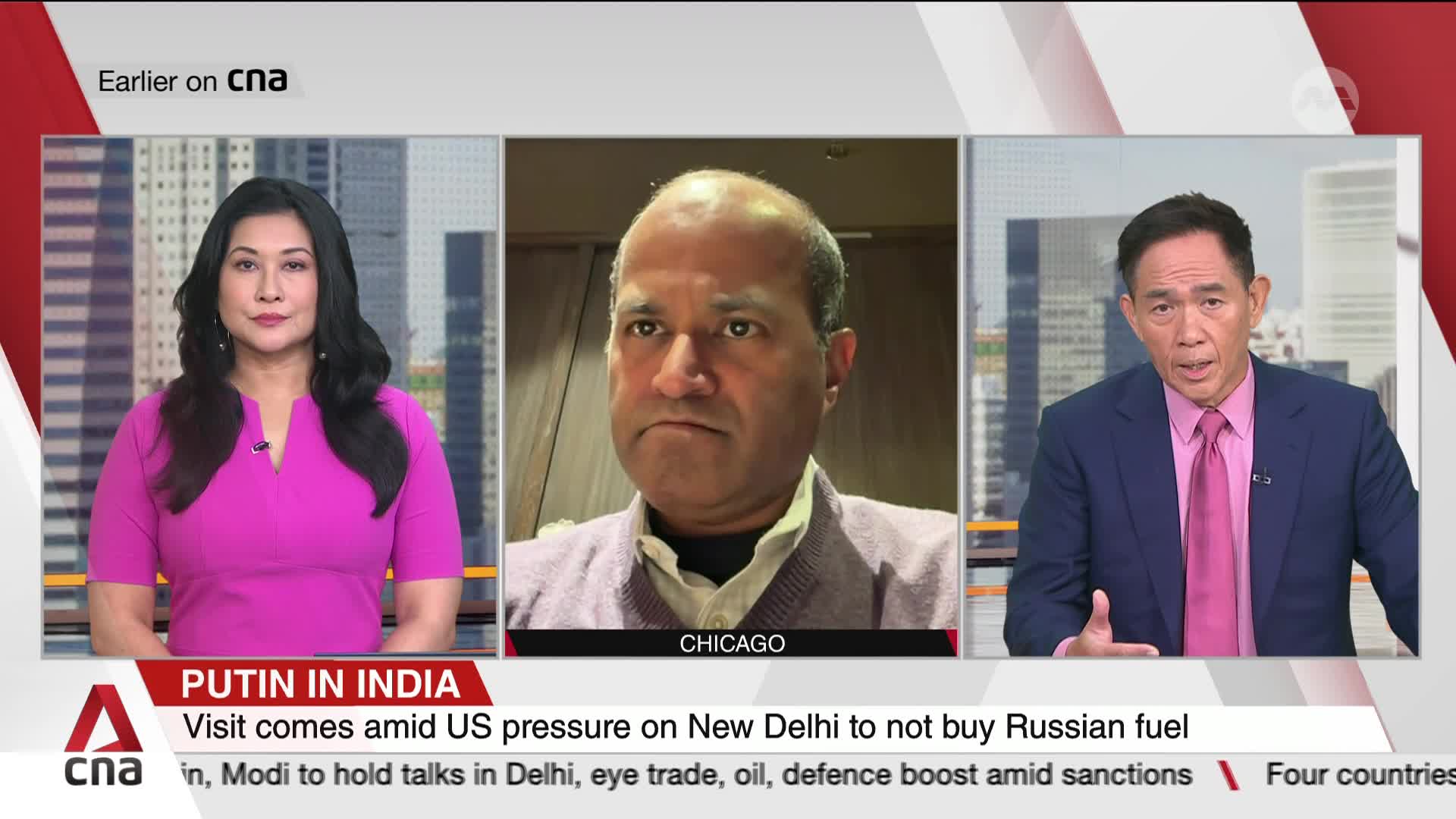 Three people are framed on a CNA International news broadcast, each in a separate panel. The woman on the left, in a bright pink dress, looks directly at the camera while the man on the right, in a suit and tie, gestures with his hands.
