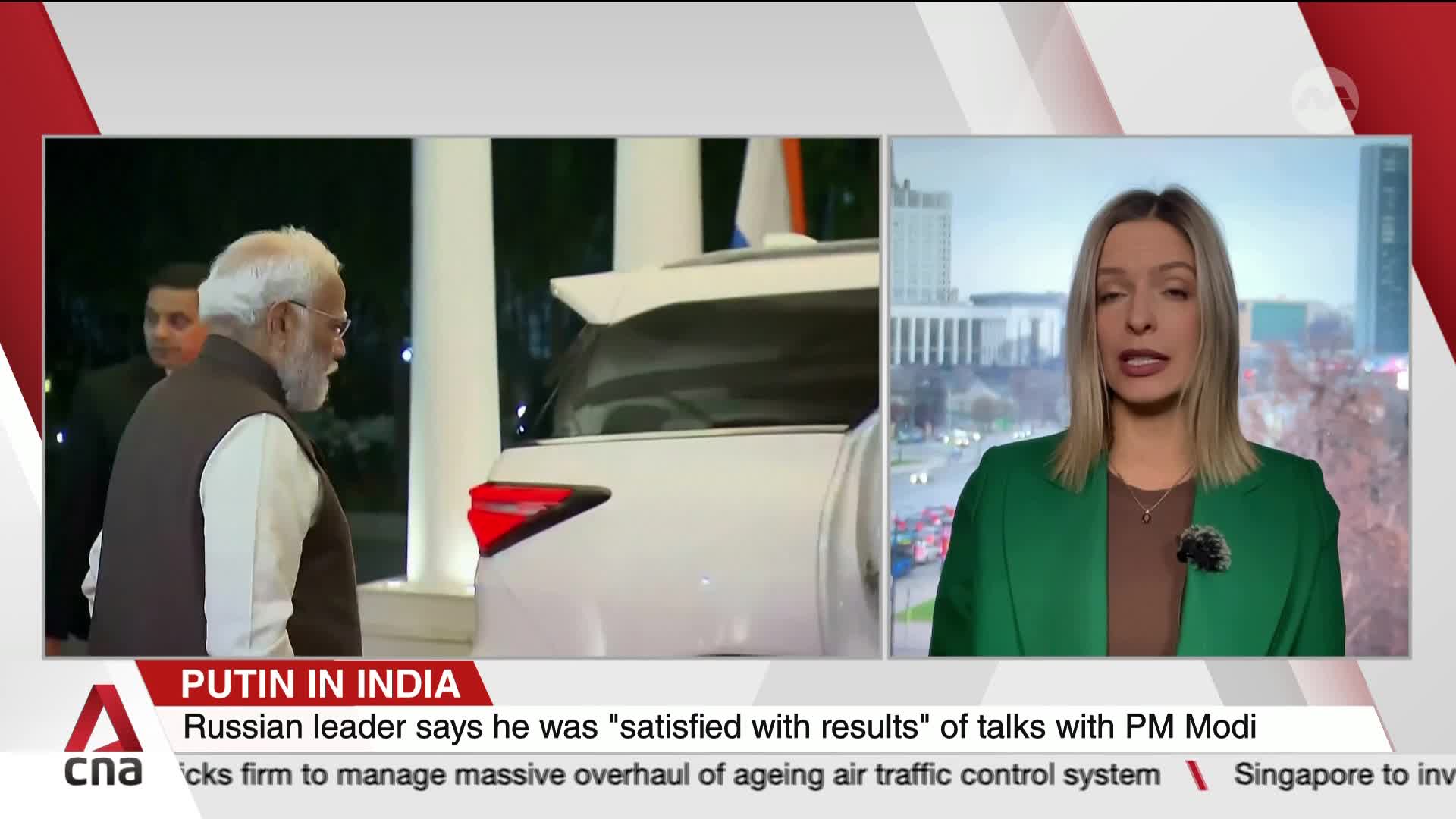 Modi, wearing a vest, walks away from a white SUV, followed by a man in a dark suit. A news anchor in a green blazer reports the story from Singapore on CNA International.
