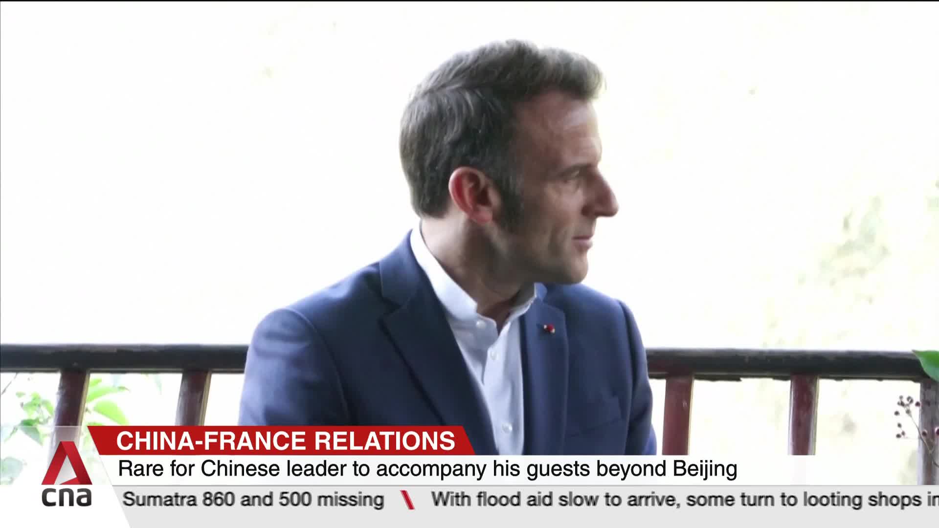 A man in a blue suit is turned to his right, listening intently. A CNA International graphic at the bottom of the screen provides context on China-France relations.
