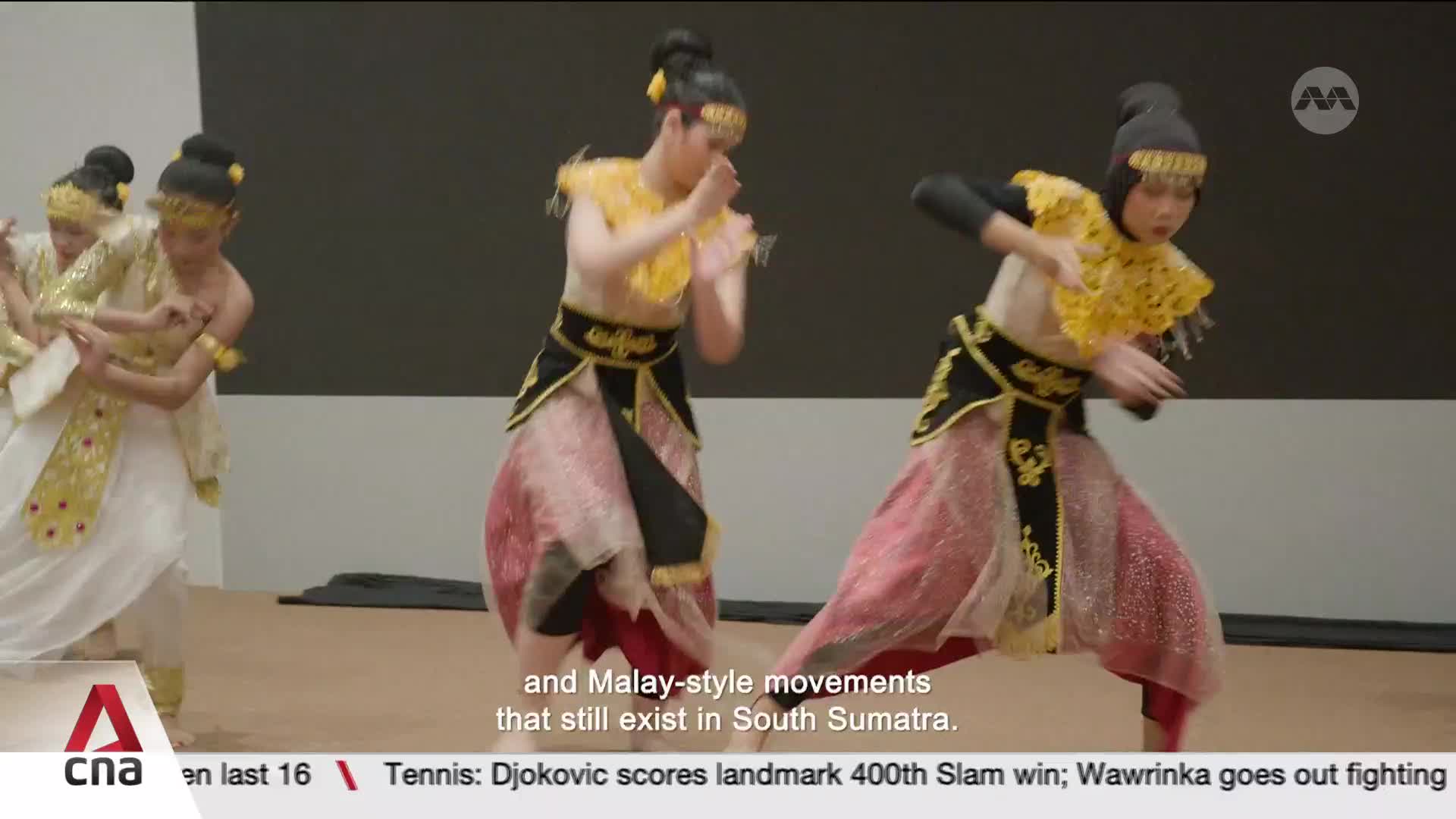 Dancers in elaborate costumes perform with fluid, graceful movements. Their arms extend and hands flutter as they move across the stage. Dancers in elaborate costumes perform with fluid, graceful movements. Their arms extend and hands flutter as they move across the stage.