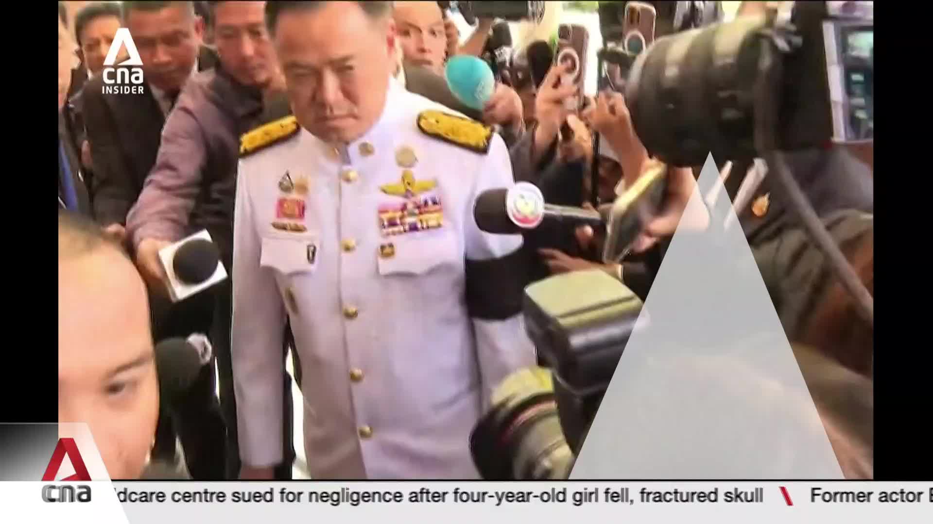 A man in a crisp white uniform, adorned with medals, walks forward through a throng of reporters. Microphones and cameras are thrust towards him, their lenses glinting under the lights. A man in a crisp white uniform, adorned with medals, walks forward through a throng of reporters. Microphones and cameras are thrust towards him, their lenses glinting under the lights.