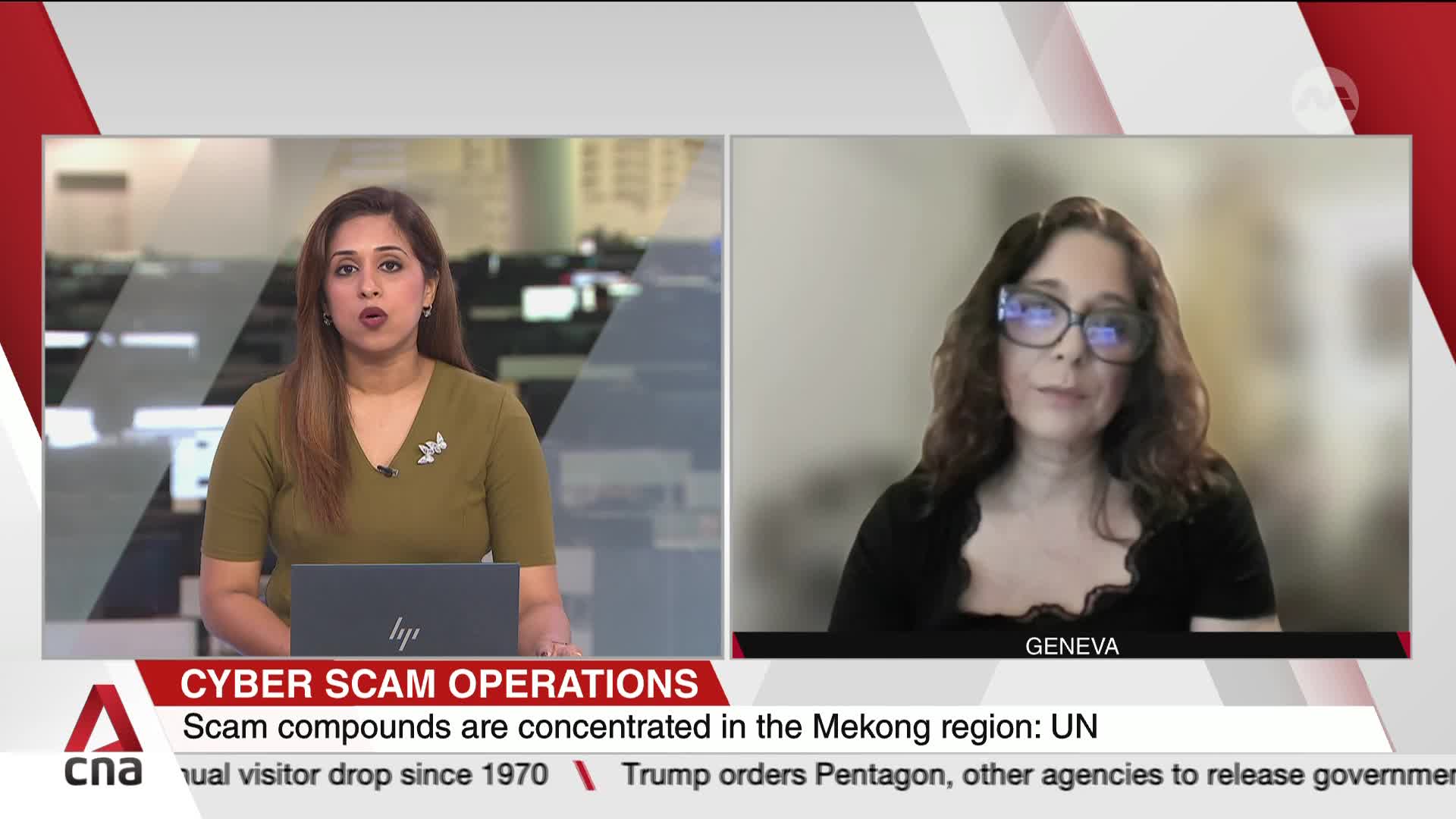 A news anchor in a green top speaks directly to the camera, while a woman in large glasses appears on a split screen, her image slightly pixelated. The words "CYBER SCAM OPERATIONS" flash across the bottom of the screen. A news anchor in a green top speaks directly to the camera, while a woman in large glasses appears on a split screen, her image slightly pixelated. The words "CYBER SCAM OPERATIONS" flash across the bottom of the screen.