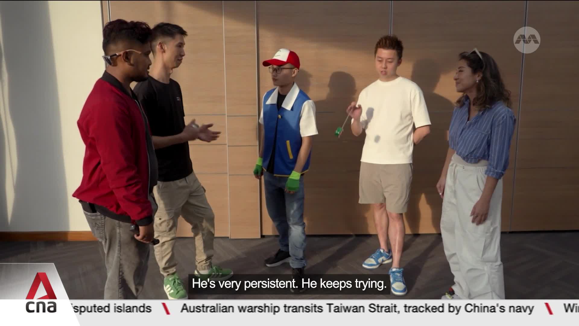 A young man in a blue vest and red cap is practicing with a yo-yo, his friends watching. The conversation, picked up by CNA, touches on his dedication. A young man in a blue vest and red cap is practicing with a yo-yo, his friends watching. The conversation, picked up by CNA, touches on his dedication.