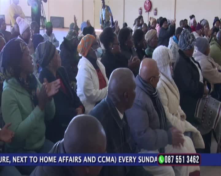 The audience is seated, many with their hands raised or clapping. A camera crew is present, and a 1KZN TV graphic is visible at the bottom of the screen.
