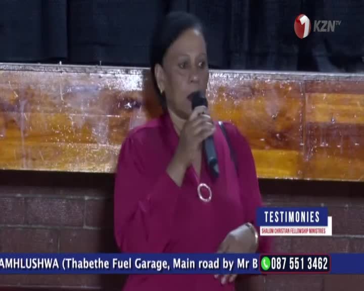 She's holding a microphone, speaking on 1KZN TV during a Shalom Christian Fellowship Ministries testimony segment. The lower third of the screen displays contact information and the location of the event in South Africa.
She's holding a microphone, speaking on 1KZN TV during a Shalom Christian Fellowship Ministries testimony segment. The lower third of the screen displays contact information and the location of the event in South Africa.