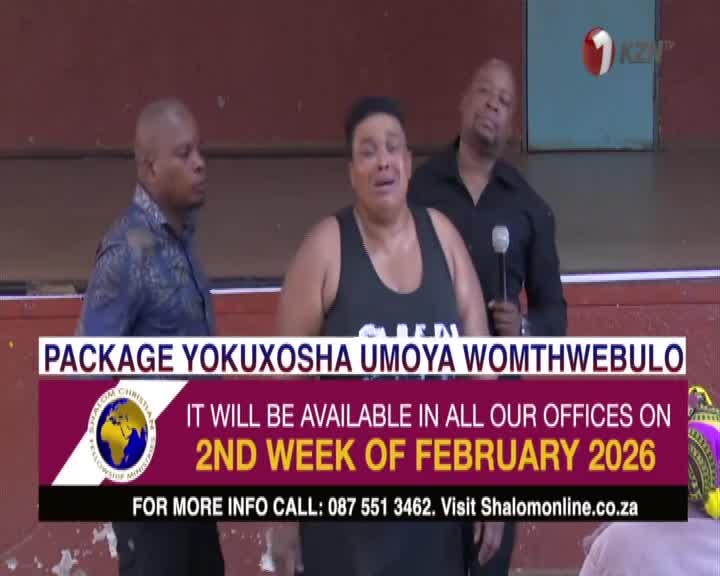 A woman in a black tank top stands center stage, her expression intense. Behind her, a man in a black shirt holds a microphone, speaking into it. A banner in the foreground announces a "PACKAGE YOKUXOSHA UMOYA WOMTHWEBULELO" available in early February 2026.