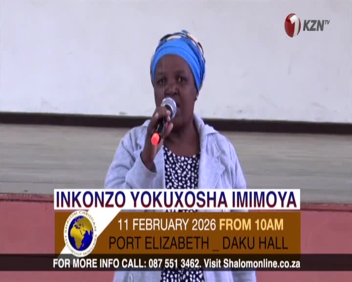 A woman speaks into a microphone, her voice amplified for the gathering. On-screen text announces an event in Port Elizabeth, South Africa, broadcast by 1KZN TV.