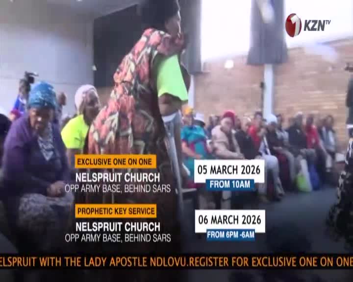 A woman in a vibrant, patterned dress stands, her back to me, as a crowd sits attentively in rows. The KZN TV logo appears in the corner, indicating this broadcast is from South Africa. A woman in a vibrant, patterned dress stands, her back to me, as a crowd sits attentively in rows. The KZN TV logo appears in the corner, indicating this broadcast is from South Africa.