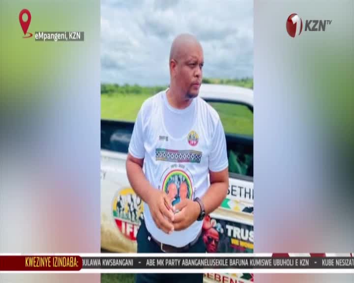 A man in a white t-shirt stands beside a vehicle, the KZN TV logo visible in the corner. The background shows a cloudy sky and open fields near eMpangeni.