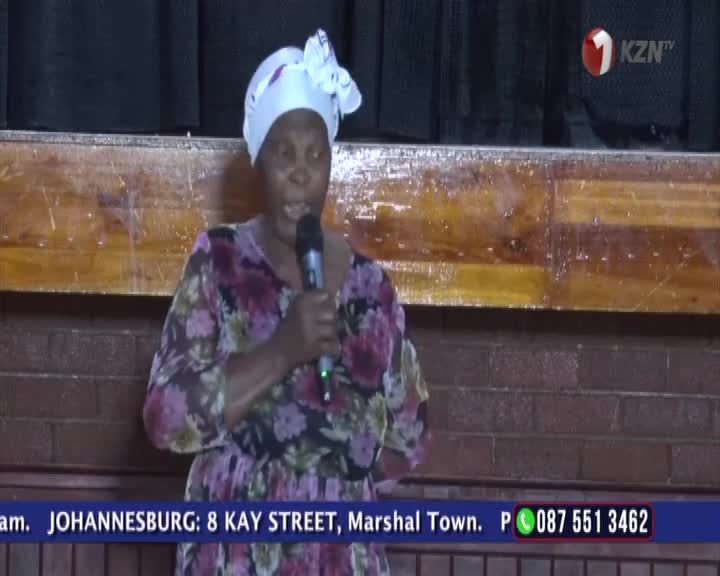A woman in a floral dress and white headscarf speaks into a microphone. The KZN TV logo appears in the corner. A woman in a floral dress and white headscarf speaks into a microphone. The KZN TV logo appears in the corner.