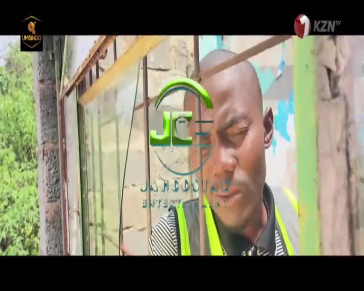 A man in a bright yellow safety vest looks intently to his left. The KZNtv logo appears in the upper right corner. A man in a bright yellow safety vest looks intently to his left. The KZNtv logo appears in the upper right corner.