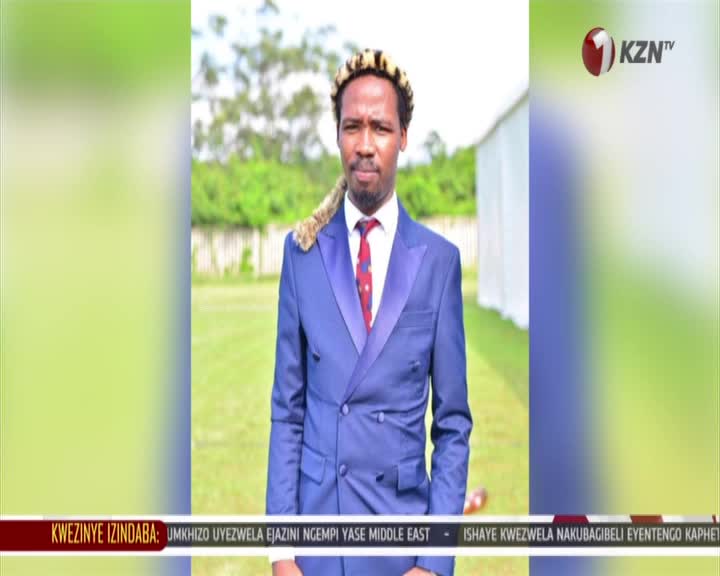 A man in a sharp blue suit stands with a leopard skin draped over his shoulders. The KZN TV logo appears in the corner, and a news ticker scrolls across the bottom.