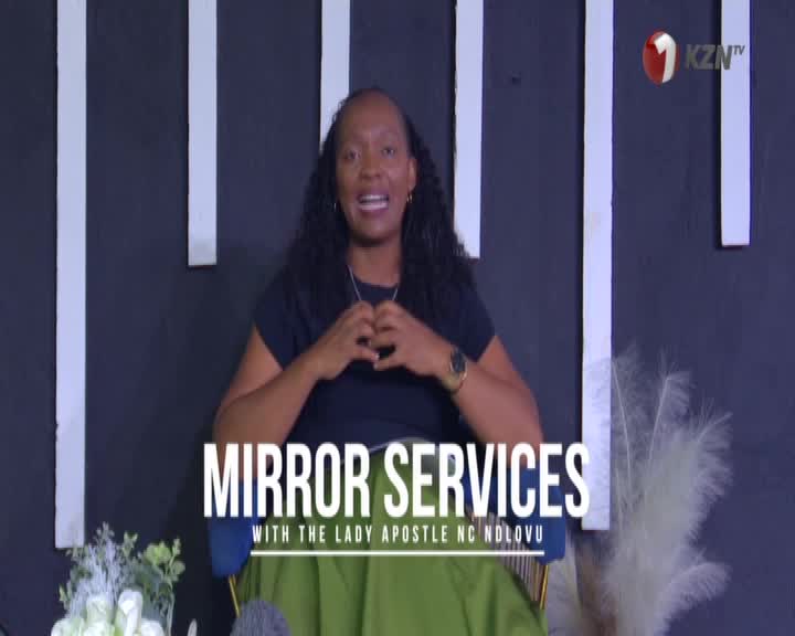 A woman with dark, curly hair, wearing a black top and a green skirt, speaks with her hands clasped in front of her. The KZN TV logo is visible in the upper right corner.