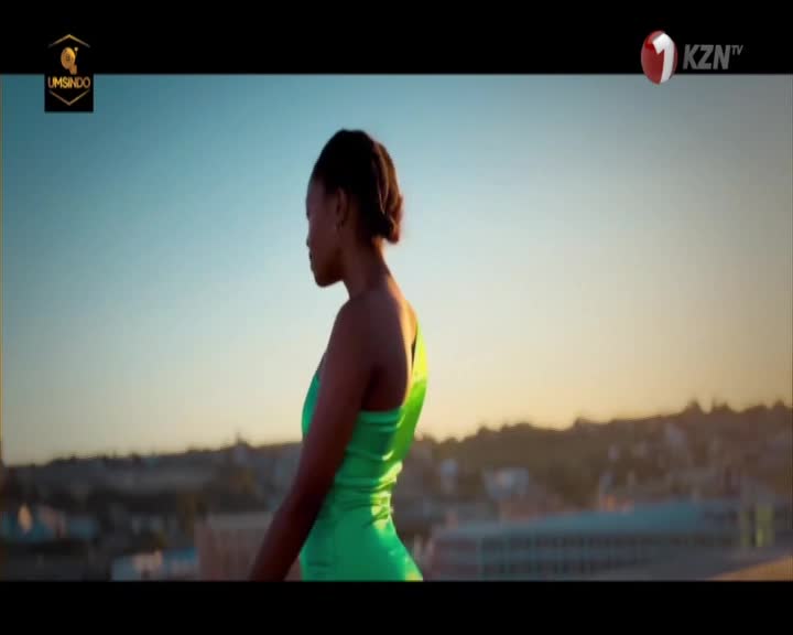 A woman in a bright green dress stands silhouetted against a pale sky, her profile turned away from the camera. The KZN TV logo appears in the corner, a familiar sight on South African screens. A woman in a bright green dress stands silhouetted against a pale sky, her profile turned away from the camera. The KZN TV logo appears in the corner, a familiar sight on South African screens.