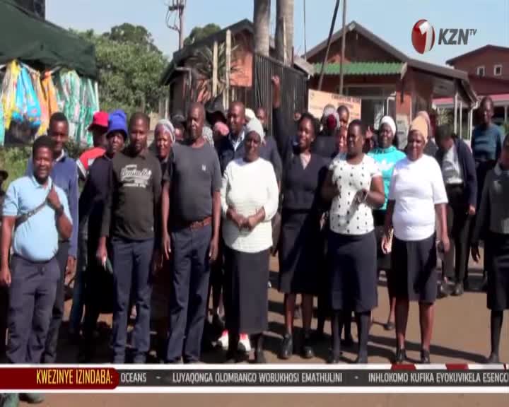 A group of people stand together, some with their hands raised, facing the camera. A KZN TV logo is visible in the upper right corner. A group of people stand together, some with their hands raised, facing the camera. A KZN TV logo is visible in the upper right corner.
