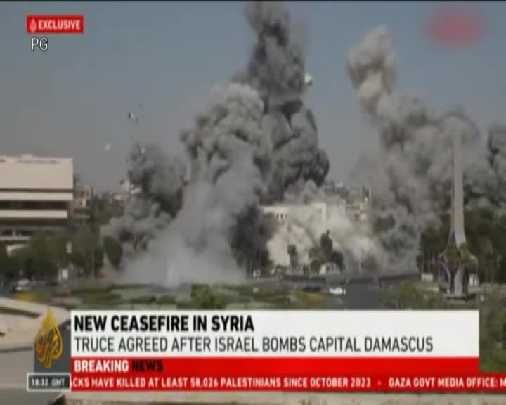 Thick, gray smoke billows upwards, obscuring buildings and the sky. The TV screen's headline announces a new ceasefire, even as the footage shows the aftermath of an explosion.
