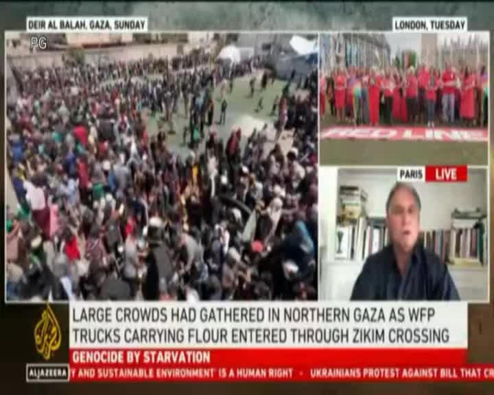 A large crowd of people is gathered in Gaza, and the image on the screen shows a live broadcast. A man in Paris is speaking, while the screen displays footage of a demonstration in London.
