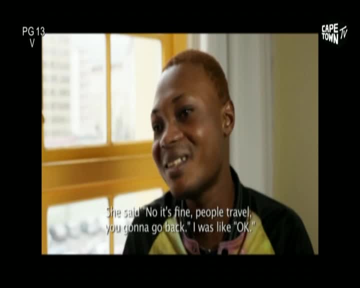 A man with short, light-colored hair smiles, looking off-camera as a caption from Cape Town TV appears below. He's recounting a conversation, the words on the screen reflecting his expression.
